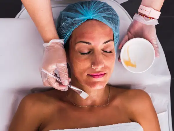 close up women receiving facial peel