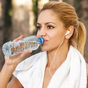 women drinking water after workout